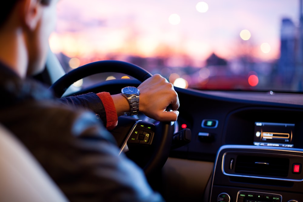 Driver behind the wheel reviewing personalised auto insurance quote options from a vetted carrier network